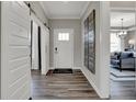 Bright hallway with hardwood floors and an open view to the living room at 13610 Grand Abbey Way, Fishers, IN 46040