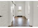 Bright entryway with hardwood floors, white walls, and a view through the glass front door at 13622 Grand Abbey Way, Fishers, IN 46040