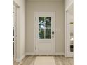 Welcoming entryway with light wood flooring and a door with glass inserts at 13634 Grand Abbey Way, Fishers, IN 46040