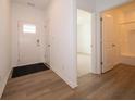 Bright entryway featuring wood-look flooring, a white front door, and neutral walls creating a welcoming space at 1366 Foxtail Ln, Greenwood, IN 46143