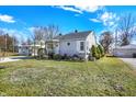 Charming one-story home with a well-manicured lawn and inviting front porch under a beautiful sky at 145 W Old South St, Bargersville, IN 46106