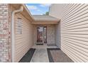 Inviting entryway showcasing the front door and side panel, plus decorative mulch at 1488 Hamilton Dr, Greenwood, IN 46143
