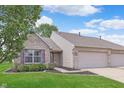 Beautiful single-story home with well-maintained lawn, garden, and attached two-car garage at 1488 Hamilton Dr, Greenwood, IN 46143