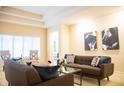 Contemporary living room featuring gray sofas, artwork, plush pillows, and a glass top table at 1502 Heron Ridge Blvd, Greenwood, IN 46143