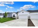 Charming home with a two-car garage, lush lawn, and stone accents, perfect for comfortable living at 1627 Clover Crossing Dr, Greenfield, IN 46140