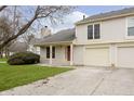 Charming two-story home with a well-manicured lawn, attached garages, and red front door at 2619 Chaseway Ct, Indianapolis, IN 46268