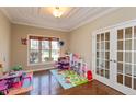 Bright playroom featuring hardwood floors, decorative tray ceiling, and natural light at 2838 Violet W Ct, Columbus, IN 47201
