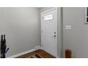 Clean foyer featuring fresh paint, hardwood floors, updated light switches, and a white door at 2951 E 62Nd St, Indianapolis, IN 46220