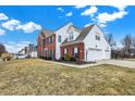 Spacious brick and siding home with a three-car garage and well-kept lawn, perfect for suburban living at 3236 Springs Way Dr, Bargersville, IN 46106