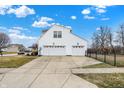 Attached three car garage with modern doors and expansive driveway, offering ample parking space at 3236 Springs Way Dr, Bargersville, IN 46106