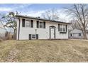 Charming two-story home with a white exterior, black shutters, and a well-manicured lawn at 4249 Dubarry Rd, Indianapolis, IN 46226