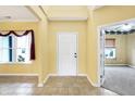 Inviting foyer with neutral tile flooring, a large window and view of a room through french doors at 4323 Elkhorn Dr, Westfield, IN 46062