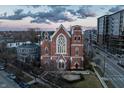 An aerial view of a beautiful brick church with manicured landscaping with another modern building nearby at 501 Fletcher Ave # D, Indianapolis, IN 46203