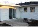 Outdoor patio area with white siding and a convenient sliding glass door at 516 Northfield Dr, Lebanon, IN 46052