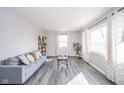 Open living space with large windows, gray flooring, and a comfortable seating arrangement at 540 Barnett Ct, Whiteland, IN 46184