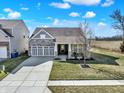 Aerial view of a charming single-Gathering home with stone accents and well-maintained landscaping at 5751 Bluff View Ln, Whitestown, IN 46075