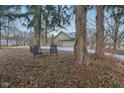Inviting backyard featuring a garage and a sitting area with lawn chairs at 605 Sugarbush Dr, Zionsville, IN 46077