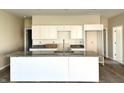 Kitchen featuring a large island with granite countertop, white cabinets, and stainless steel faucet at 614 Silver Fox Ct, Indianapolis, IN 46217