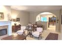 Cozy living room with fireplace, archway, and view of dining area at 6691 Beekman Pl, Zionsville, IN 46077