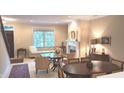 Bright living room with fireplace, window, and inviting seating area at 6691 Beekman Pl, Zionsville, IN 46077