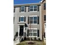 Stylish townhome with gray siding, large windows, and a well-maintained front lawn at 6882 Equality Blvd, Carmel, IN 46033