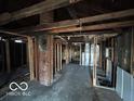 Unfinished basement area with exposed rafters and brick support column at 714 S Biltmore Ave, Indianapolis, IN 46241