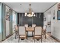 Dining room with wood table, fabric chairs, and a modern light fixture at 7450 Leatherwood Dr, Indianapolis, IN 46259