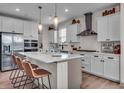 Gourmet kitchen with white cabinets, stainless steel appliances, and a large center island at 7450 Leatherwood Dr, Indianapolis, IN 46259