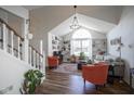 Bright living room boasts vaulted ceilings, a large window, built-in bookshelves and modern decor at 10920 Gate Cir, Fishers, IN 46038
