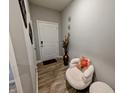 Inviting foyer with wood floors, seating area, and decorative wall accents at 11064 N Sashing Way, Monrovia, IN 46157