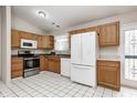 Bright kitchen featuring white appliances, wooden cabinets and ample counter space at 11363 Kristen Ln, Indianapolis, IN 46235
