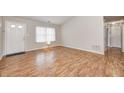 Inviting living room showcasing hardwood floors, a bright window, and an entry door at 11363 Kristen Ln, Indianapolis, IN 46235