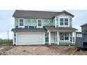 New two-story home features a two-car garage and a covered front porch that is currently under construction at 1346 Fleming Dr, Greenfield, IN 46140