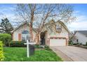Inviting home with a well-manicured lawn and a classic, timeless design at 13841 Waywing Ct, Carmel, IN 46033