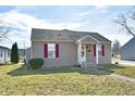 Charming single-story home featuring gray siding, a gray roof, and well-maintained landscaping at 1507 Park Dr, Lebanon, IN 46052