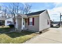 Charming single-story home featuring gray siding, a gray roof, and well-maintained landscaping at 1507 Park Dr, Lebanon, IN 46052