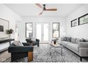 Bright living room with modern decor, stylish rug, and a ceiling fan at 1526 Laurel St, Indianapolis, IN 46203