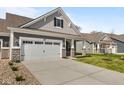Inviting home featuring a large driveway leading to a two-car garage, complemented by a well-maintained lawn at 16771 Cattle Hollow Ln, Noblesville, IN 46060