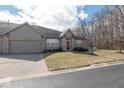 Inviting brick exterior with an attached garage and landscaped front yard with lawn at 18357 Piers End Dr, Noblesville, IN 46062