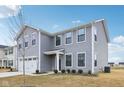 Charming two-story home with gray siding, a two-car garage, and manicured front yard at 1854 Cascades Dr, Greenfield, IN 46140