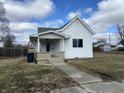 Charming single-story home with a welcoming front porch, concrete walkway, and well-kept lawn at 2712 S A St, Elwood, IN 46036