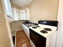 Functional kitchen equipped with white appliances, a stainless steel sink, and ample counter space at 2821 E 13Th St, Indianapolis, IN 46201
