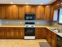 Traditional kitchen with wooden cabinets, laminate countertops, and updated appliances at 316 Elm St, Greenwood, IN 46142