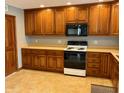 Warm kitchen with wooden cabinets, laminate countertops, and new appliances at 316 Elm St, Greenwood, IN 46142