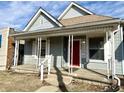 Charming home featuring a covered front porch and a striking red front door at 3426 W Michigan St, Indianapolis, IN 46222