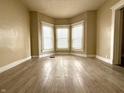 Bright living room featuring wood floors and a bay window for ample natural light at 3426 W Michigan St, Indianapolis, IN 46222