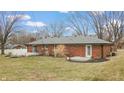 Spacious backyard featuring a well-maintained lawn, mature trees, and two wooden decks for outdoor living at 3779 W County Line Rd, Greenwood, IN 46142