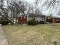 Side view of home featuring brick and stone accents and a well-maintained lawn at 3851 N Campbell Ave, Indianapolis, IN 46226