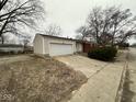 Detached two-car garage with concrete driveway in need of repair at 3851 N Campbell Ave, Indianapolis, IN 46226