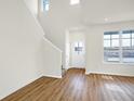 Spacious living room with plenty of natural light, hardwood floors and staircase at 3913 Wren Dr, Brownsburg, IN 46112